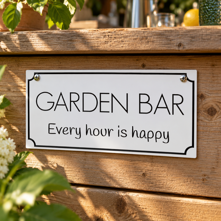 White engraved Garden Bar sign screwed onto a wooden outdoor bar in a garden