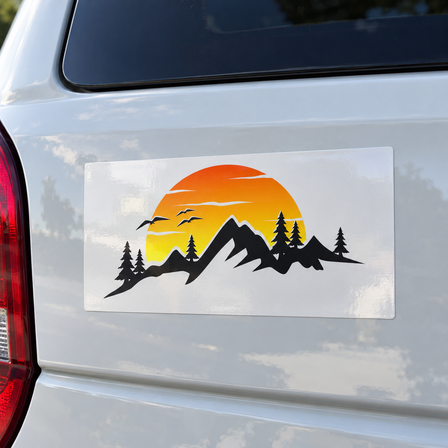 Glossy vinyl sticker with a mountain sunset design applied to the rear of a white car
