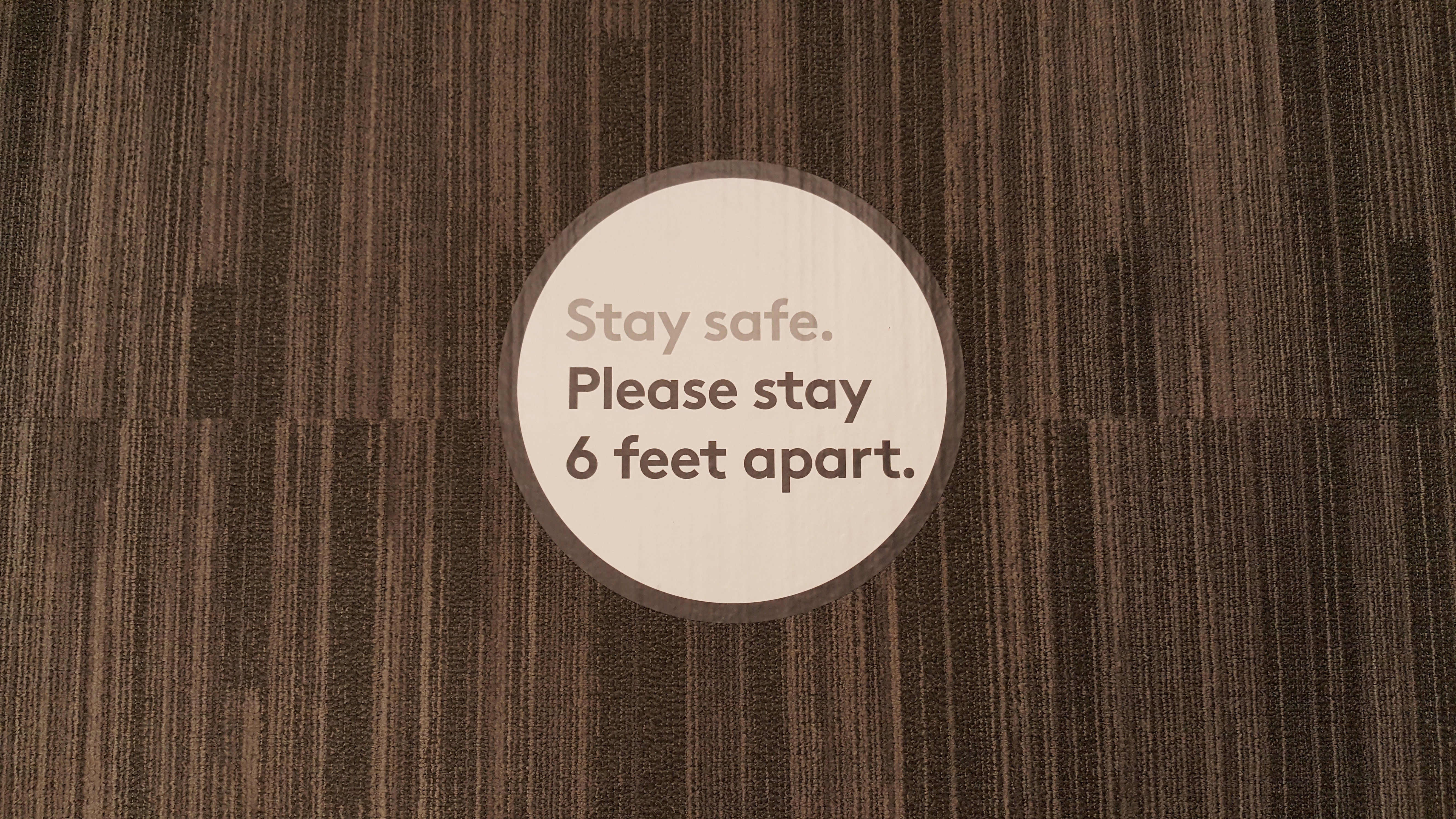 Oval floor decal displaying safety instructions