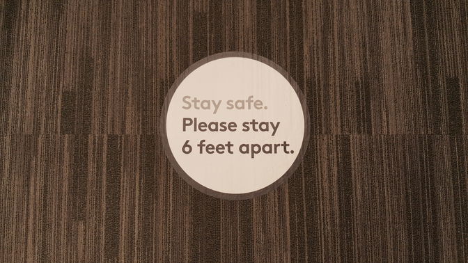 Oval floor decal displaying safety instructions