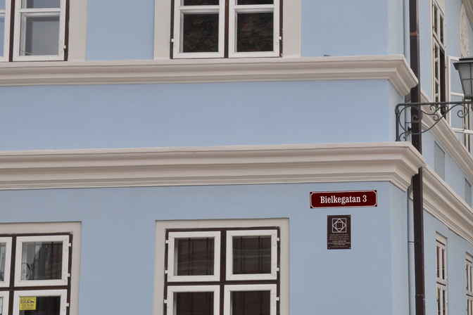 Personalised street sign mounted on a building facade