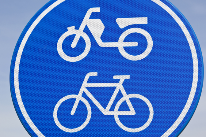 Panneau routier ovale bleu avec symbole blanc